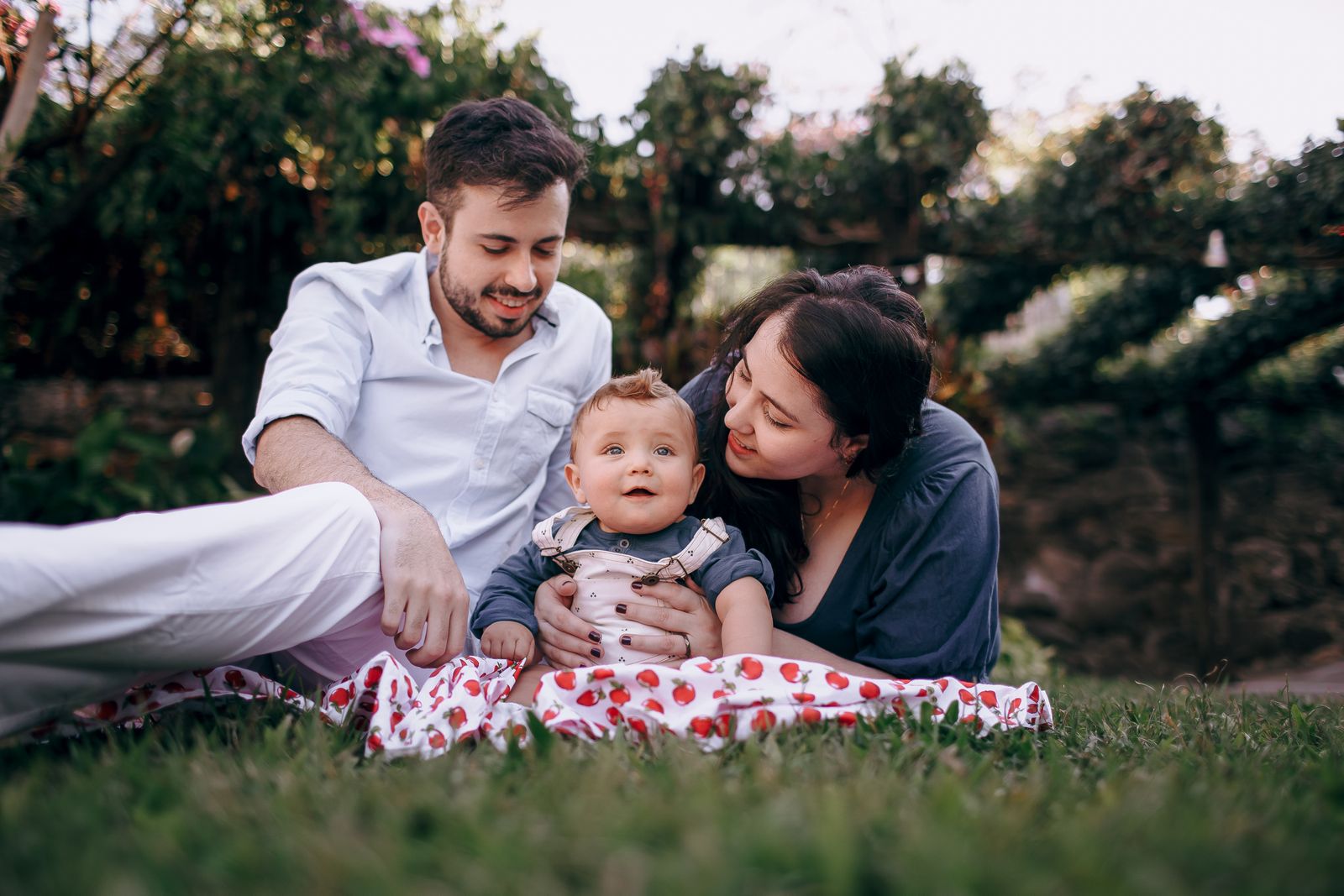 A young family enjoying a relaxed picnic together outdoors