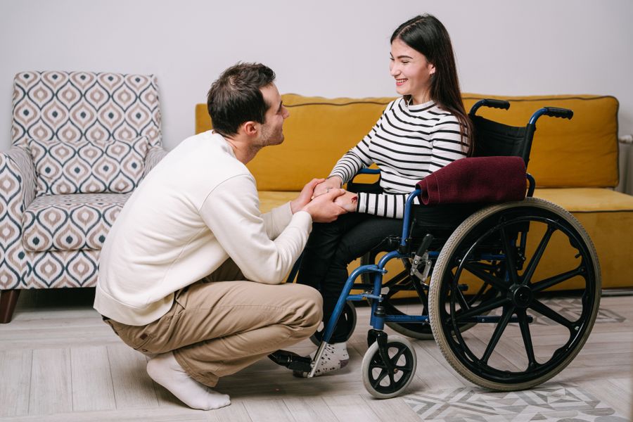 A man holding a woman's hands in a moment of support and reassurance